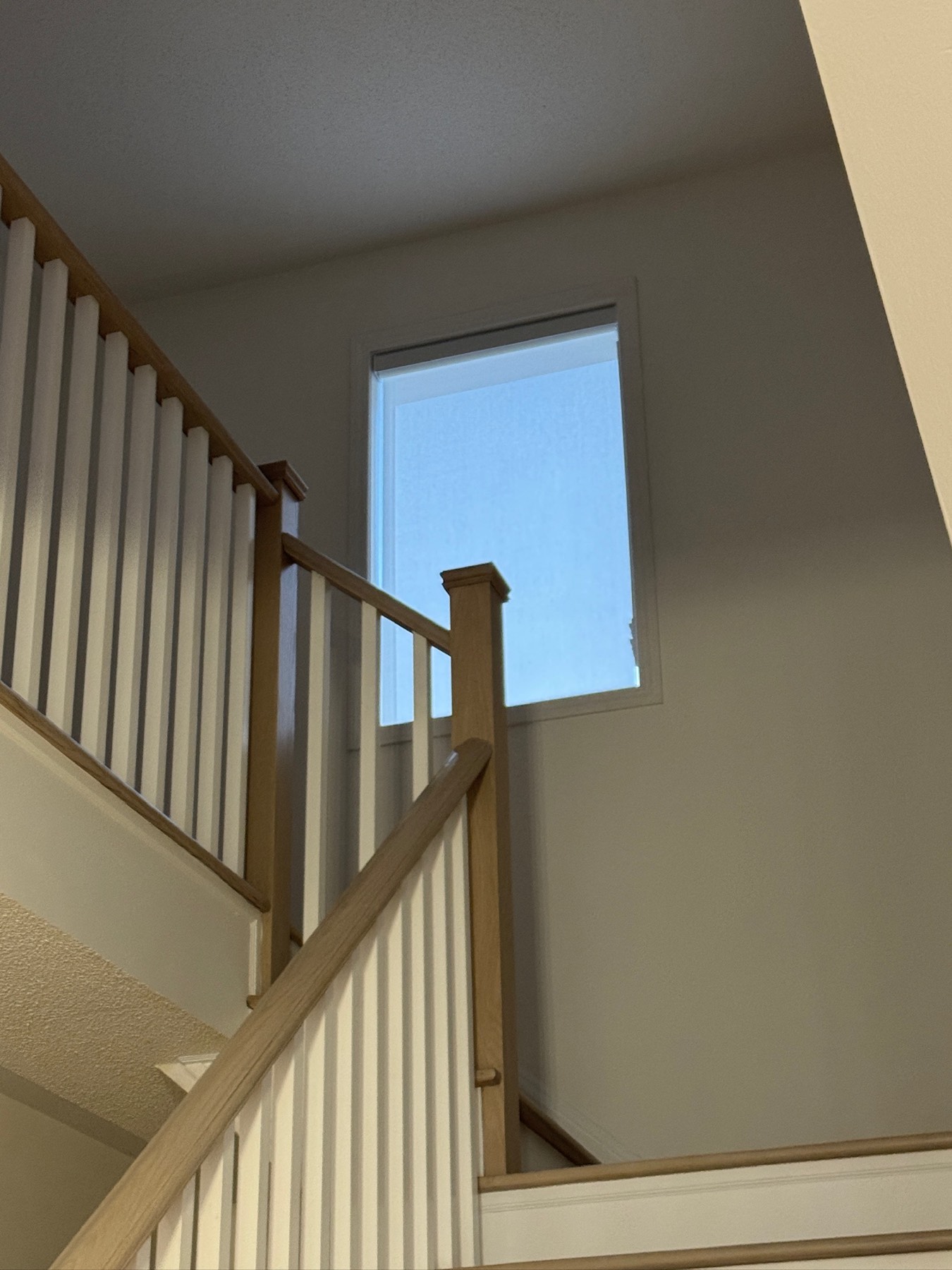 Roller shade fitted to a high stairwell window that cannot be reached from the floor